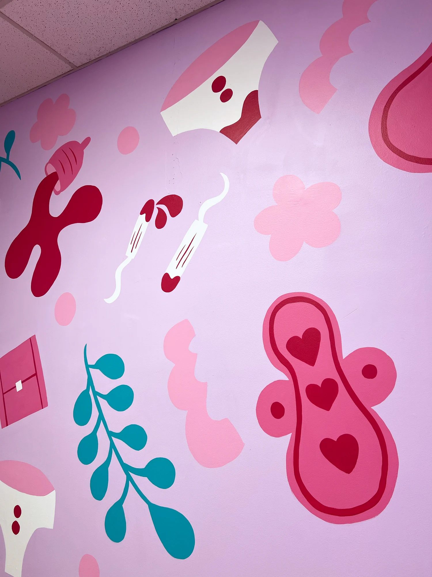 Detail of the mural showing layered pink and red organic shapes and teal leaves