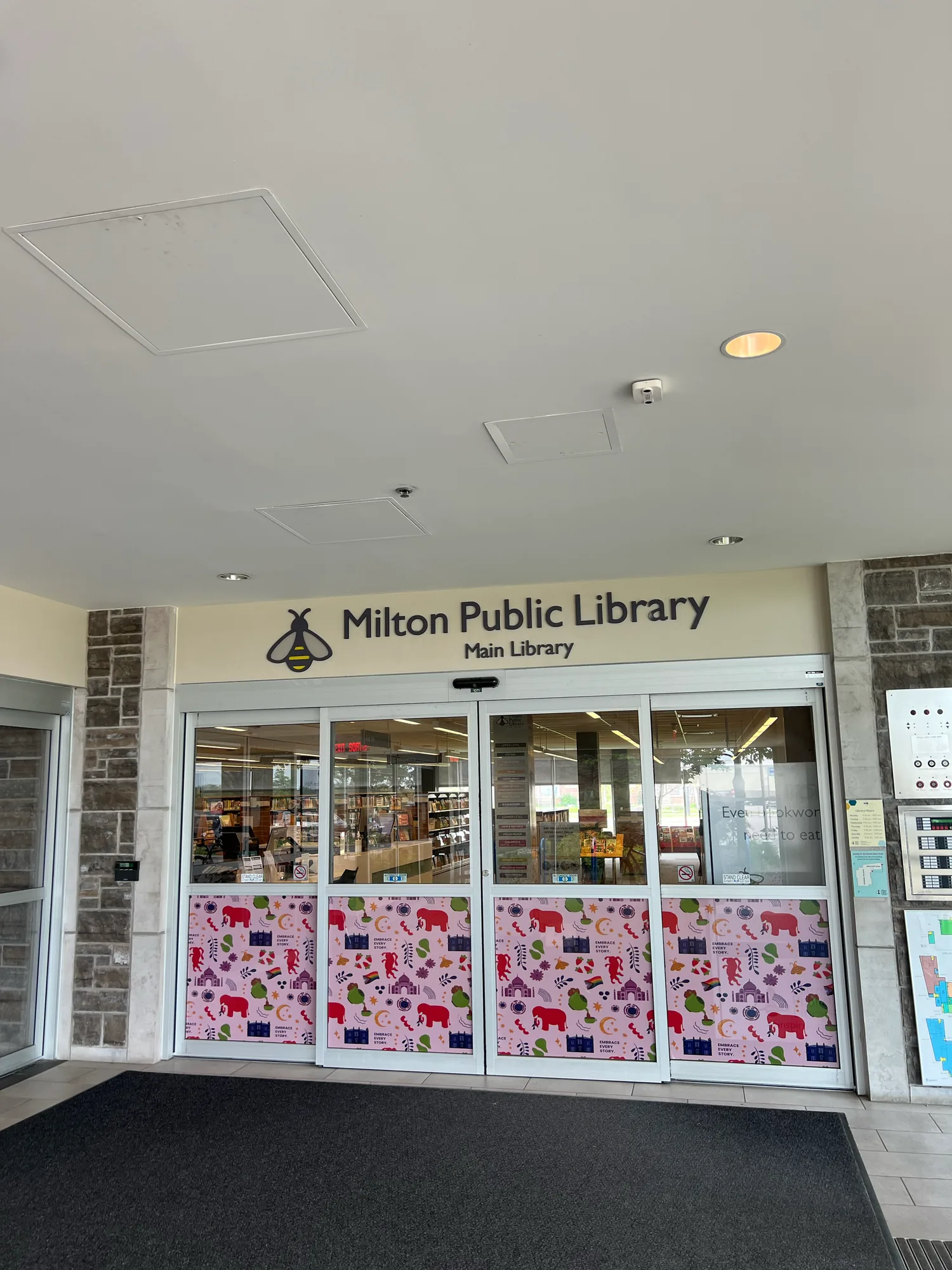 The Milton Public Library Main branch entrance with the patterned vinyl across the windows