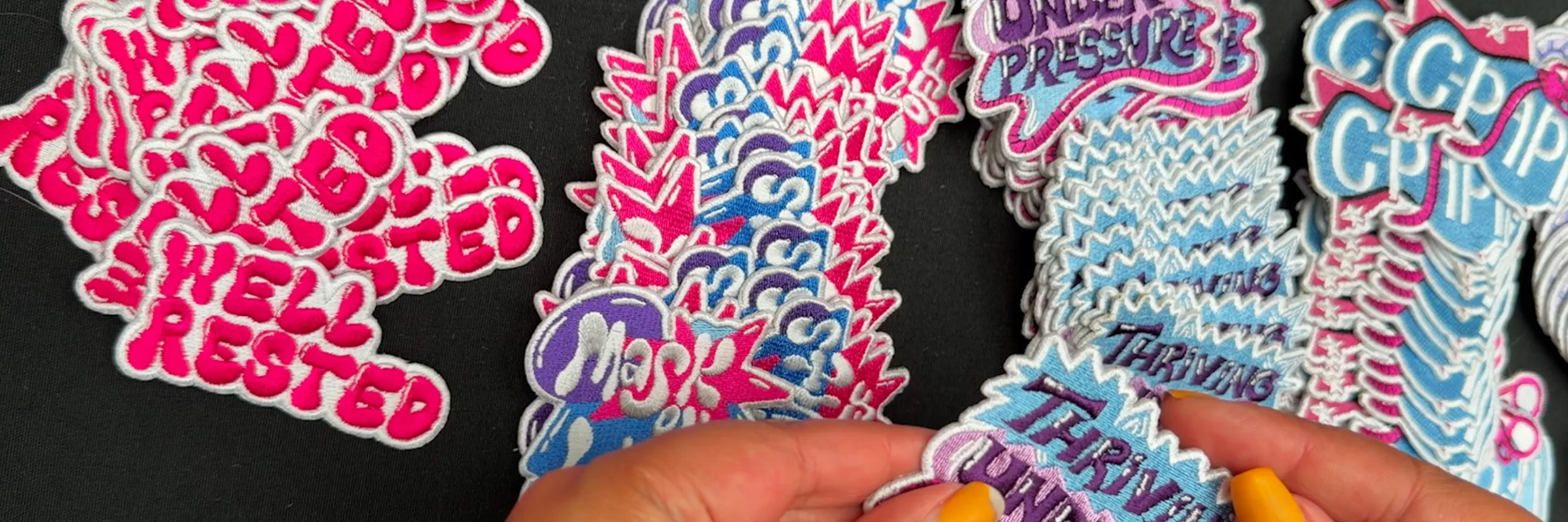 Embroidered patches designed by Saphera Peters for Resmed, including Thriving Under Pressure, C-PAPI and Well Rested