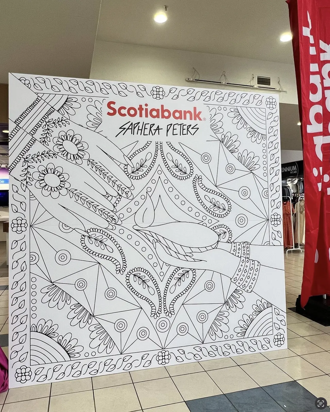 The Scotiabank Diwali colouring wall before the event, uncoloured, beside Scotiabank banners