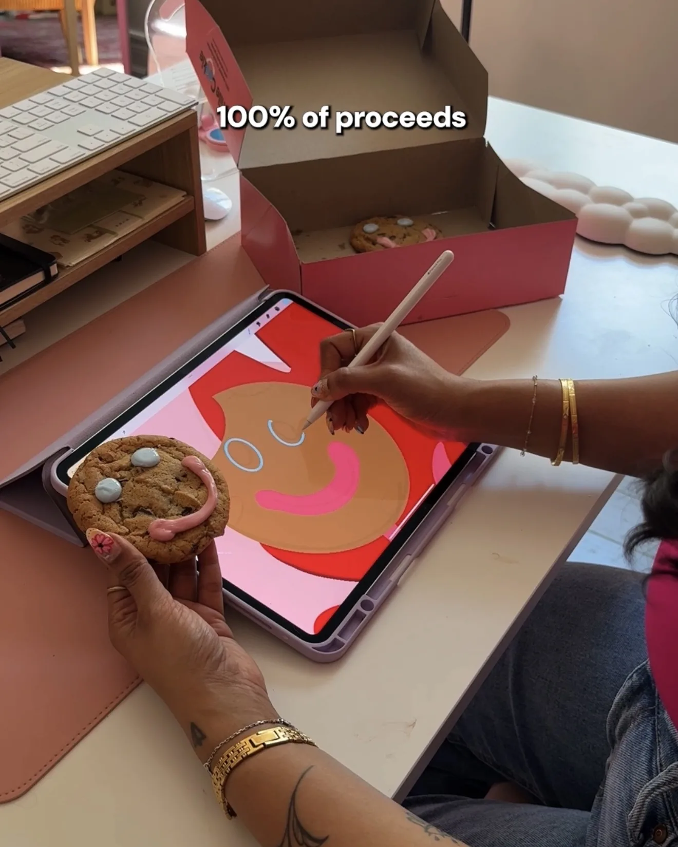 Saphera drawing the Smile Cookie illustration on an iPad while holding a Smile Cookie